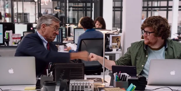 two men doing a fist bump in the office