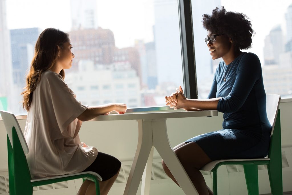 Two women speaking with each other